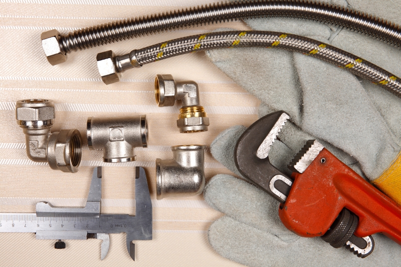Plumber working on pipes in a Twickenham home